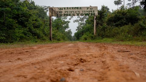 A sign reading “Welcome to the people’s temple Jonestown” stands at the entrance to the former Jonestown site in Port Kaituma, Guyana, on March 8, 2025.(Will Lanzoni/CNN)