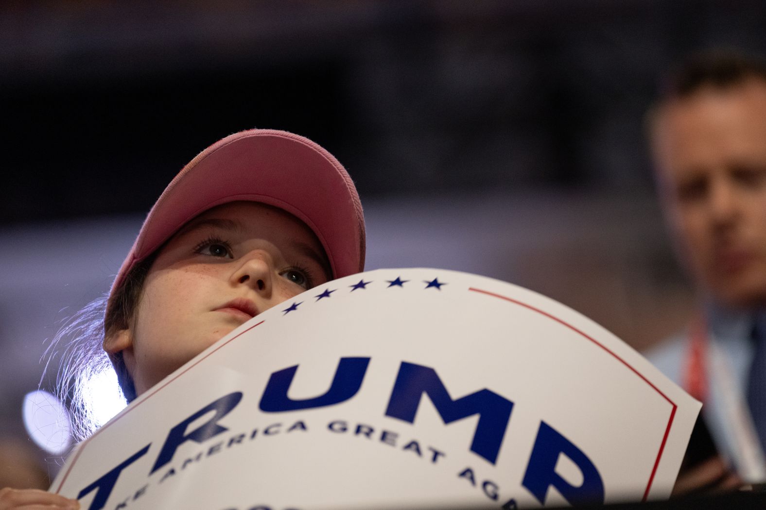 A child holds a Trump sign at the convention on Monday.