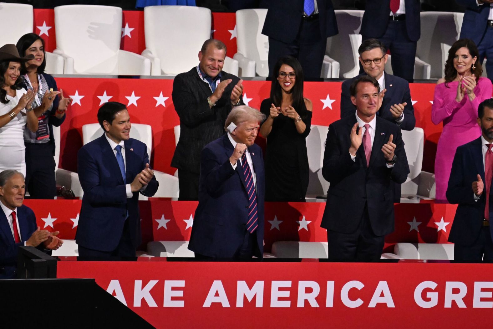 Trump raises a fist after arriving to the Fiserv Forum on Wednesday.