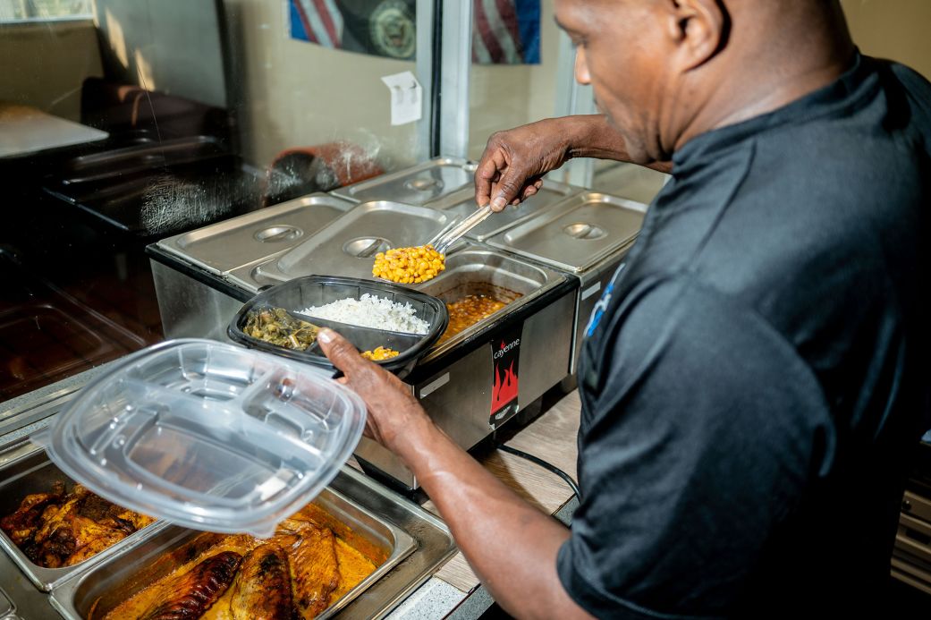 Soul Good Fine Food owner Clifford Simpson prepares a take-out order in Atlanta on June 10.