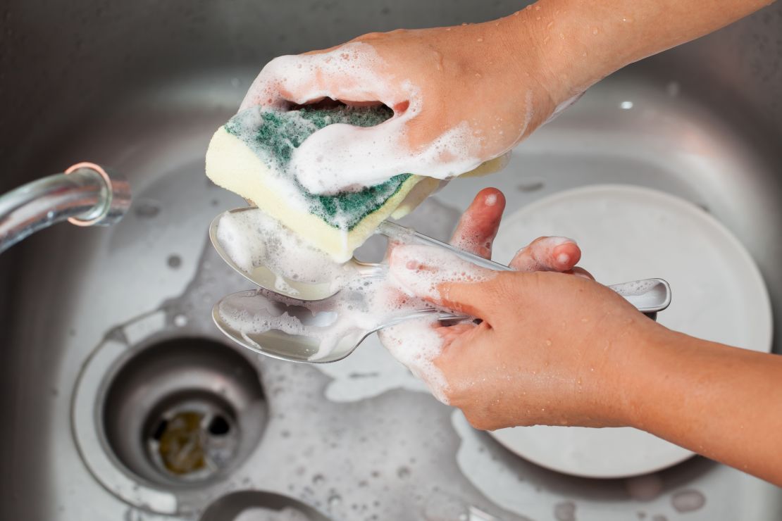 woman-hand-washing-silver-spoons-with-soapy-water-over-kitchen-sink.jpg