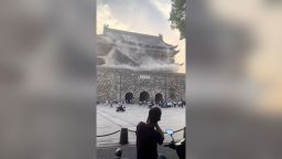 This screengrab taken from a video shows roof tiles collapsing from a centuries-old Chinese drum tower in Anhui, China, on Monday, May 19, 2025.