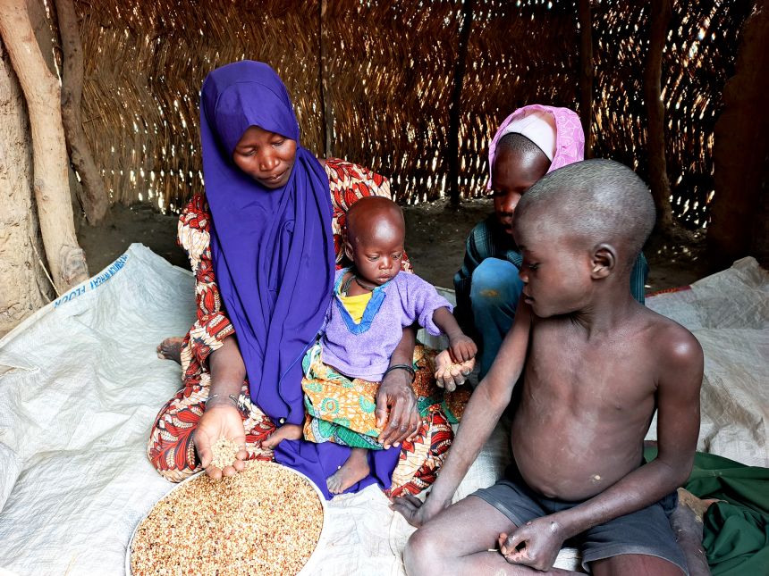 Yagana Usman and her children are sitting on the last groceries they received from the World Food Program at Fulatari Camp on September 5, 2025.