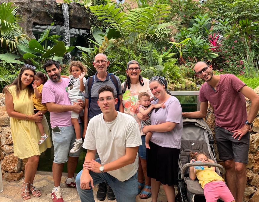 Nicky and Chantal Young (center) surrounded by their family. Their youngest child, Nathanel (pictured in a white t-shirt at the front), was killed by Hamas on October 7, 2003.