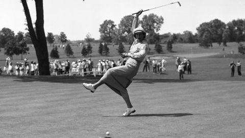 Babe Didrikson Zaharias urges the ball into the cup on the 18th green of Chicago's Tam O'Shanter Country Club in the Women's All-American Golf Tournament on Aug. 4, 1950. (AP Photo/Ed Maloney)