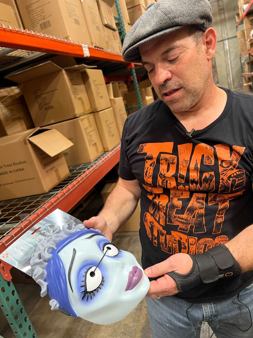 Chris Zephro shows a plastic mask made in China, currently subject to 30% tariffs.