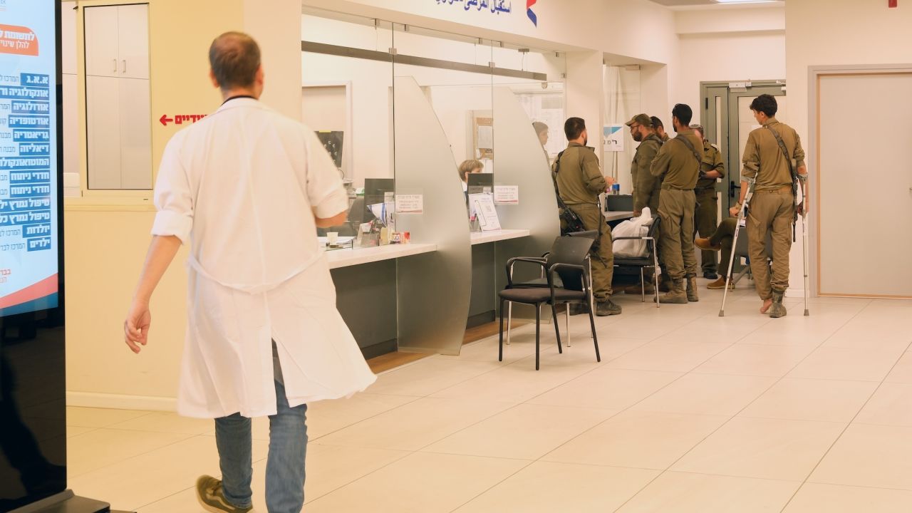 Soldiers, including several visibly injured, are seen at the emergency department’s reception desk at the Ziv hospital.