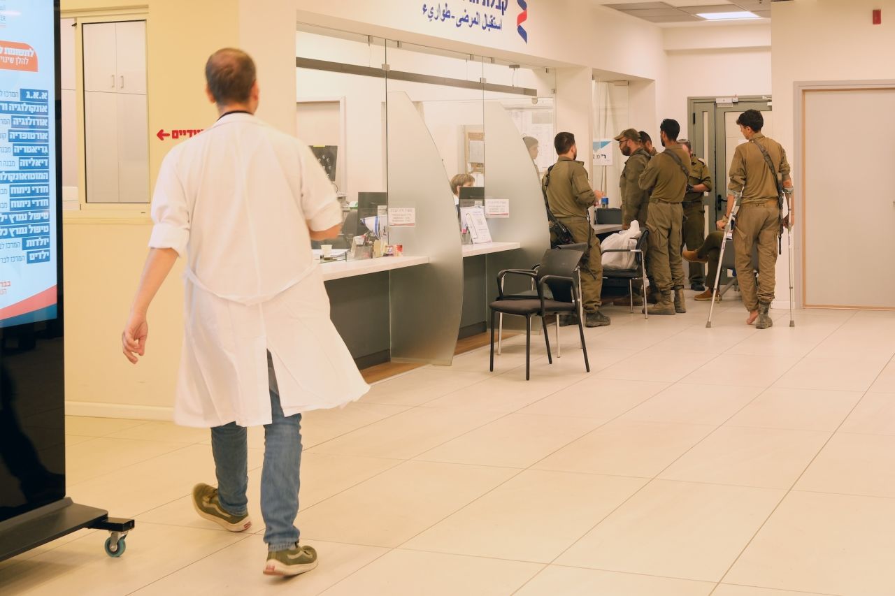 Soldiers, including several visibly injured, are seen at the emergency department’s reception desk at the Ziv hospital.