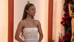 Zoe Saldana poses on the red carpet at the 2023 Academy Awards