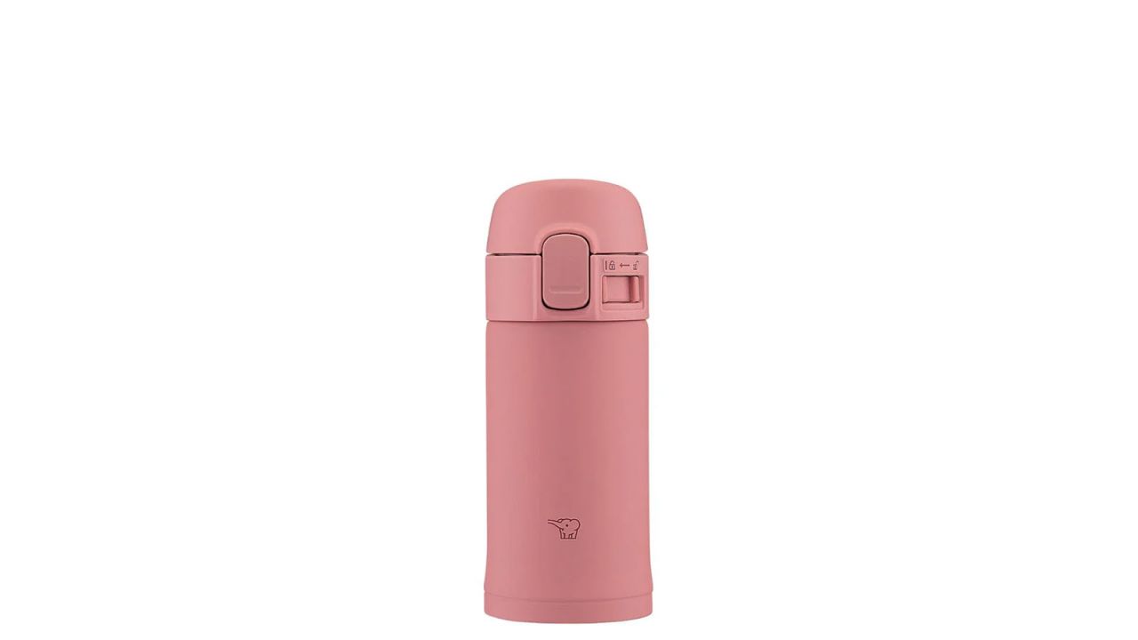 Small pink travel mug placed against white background.