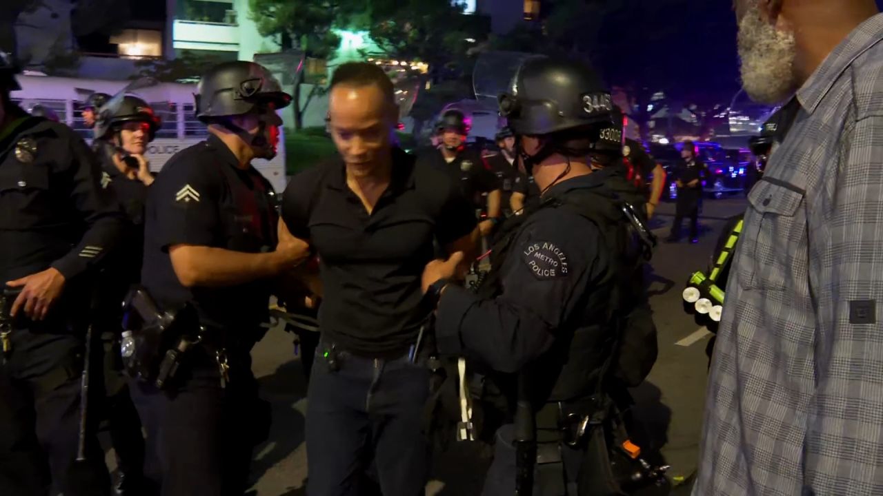 <p>CNN's Jason Carroll escorted out of LA protest zone by police officers.</p>