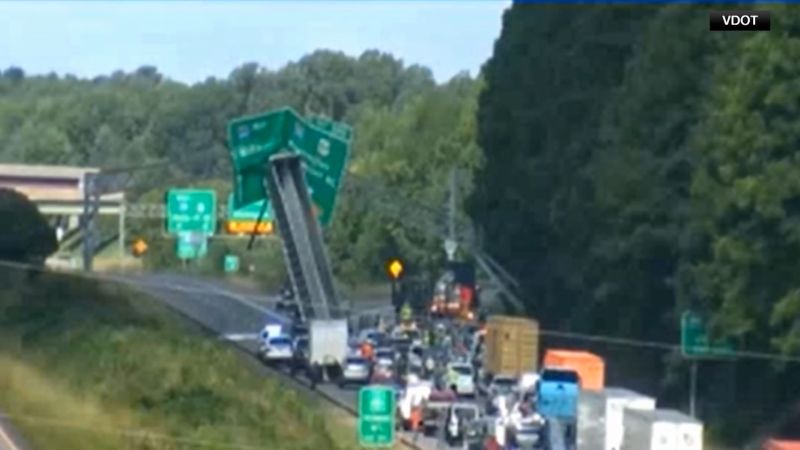 A highway accident leaves a truck trailer standing upright